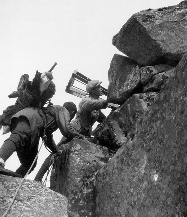 Topografer p&aring; vei til toppen av Dyrhaugstinden i 1923.